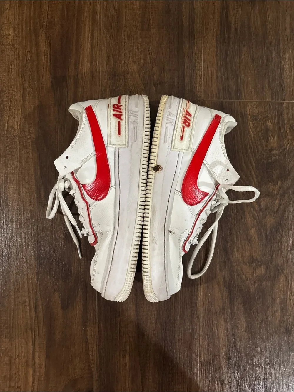 Nike Air Force 1 white sneakers with red Nike swoosh